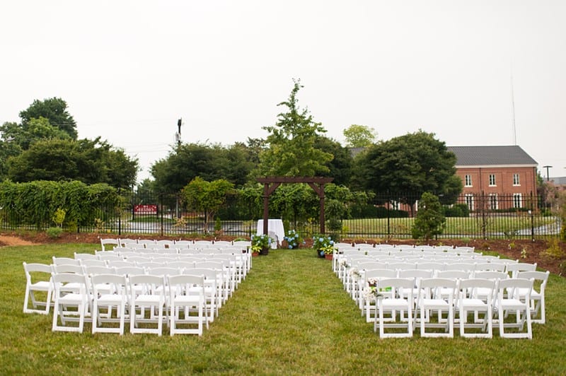 Outdoor wedding ceremony under an arbor- A.J. Dunlap Photography