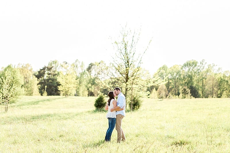 wake forest nc bride and groom kissing in a field photo