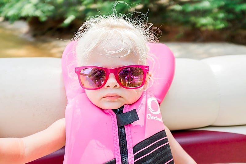 toddler style in life jacket and pink sunglasses photo