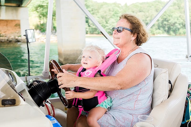 lake keowee toddler driving a pontoon photo