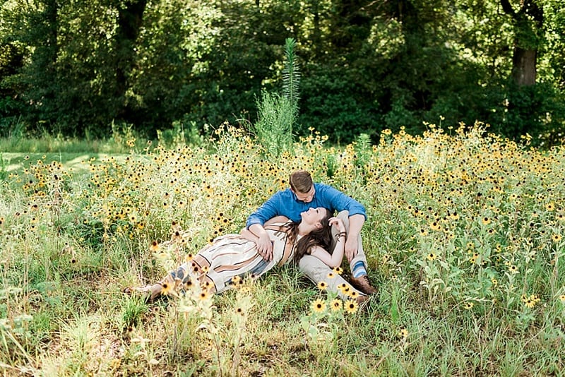 engagement photos lying down in a field of wildflowers photo