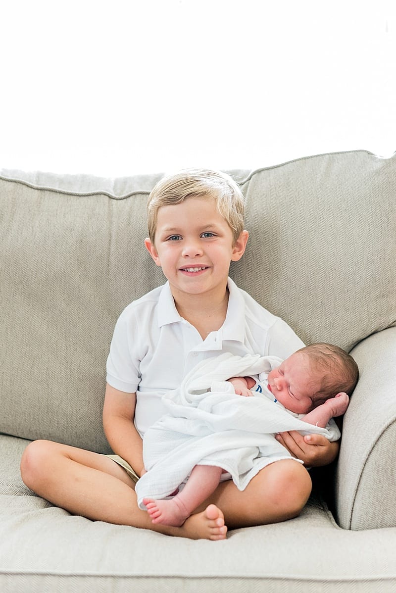newborn boy with his big brother photo
