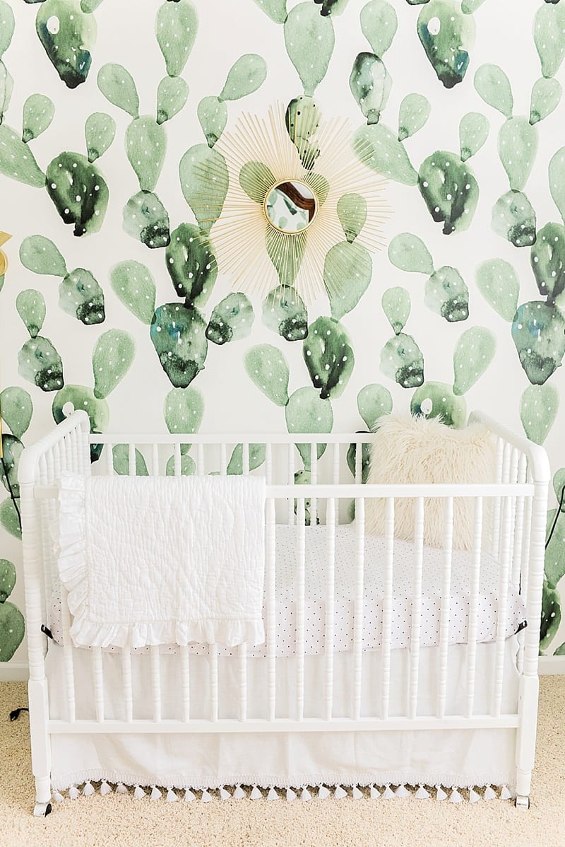 white crib with cactus wall paper photo
