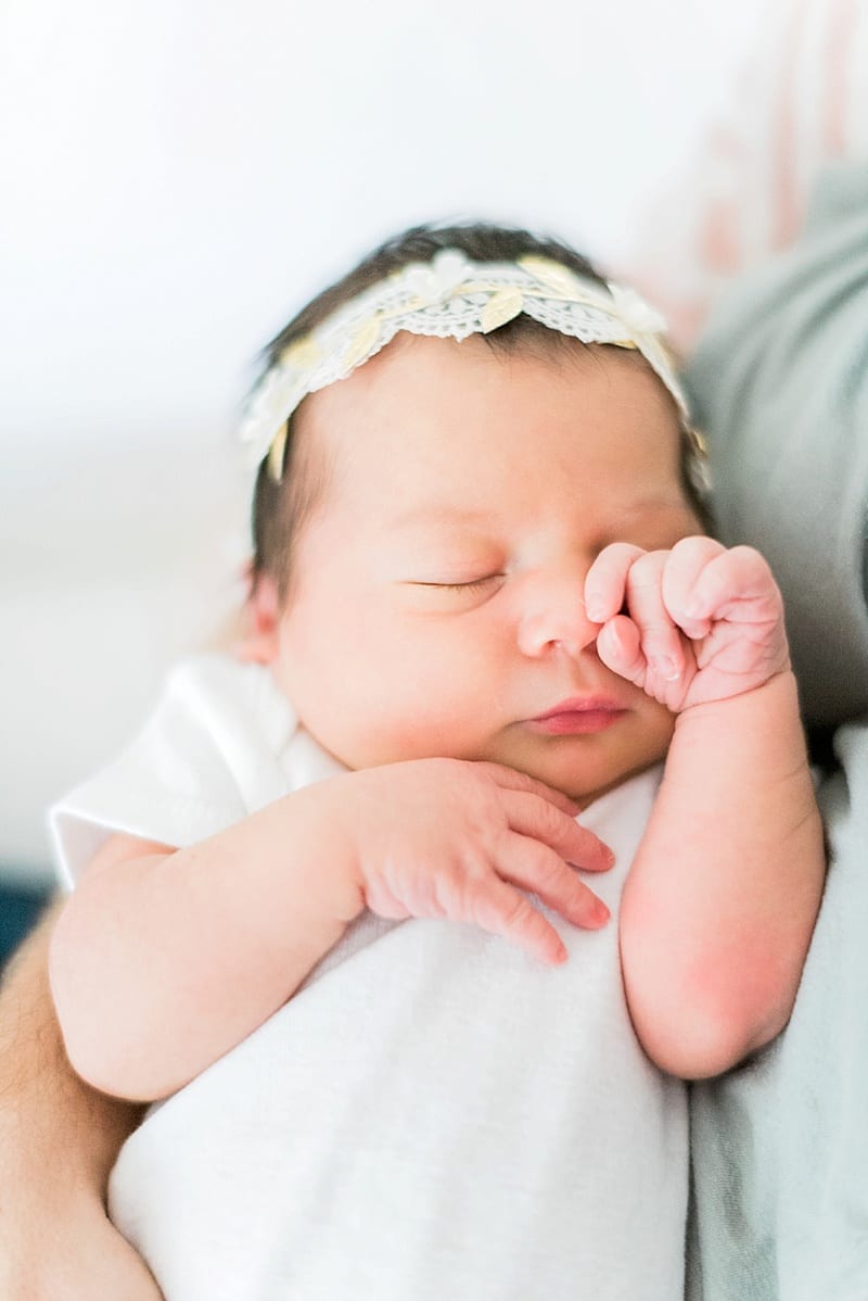 newborn baby rubbing eyes photo