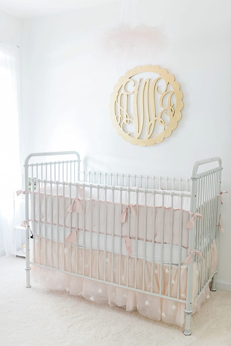pink and white crib in a baby nursery photo