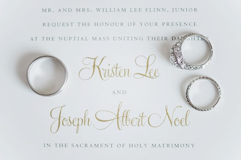 wedding rings on white and gold invitation photo