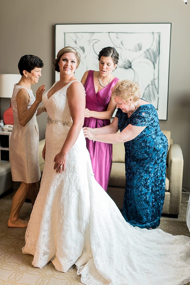 proximity hotel mom helping bride get dressed photo