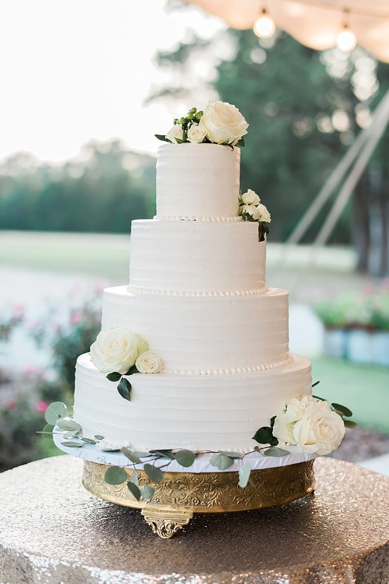 classic white wedding cake with eucalyptus embellishments photo