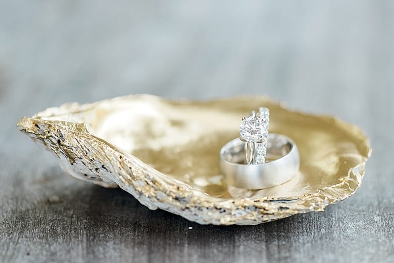 wedding rings on a golden oyster shell photo