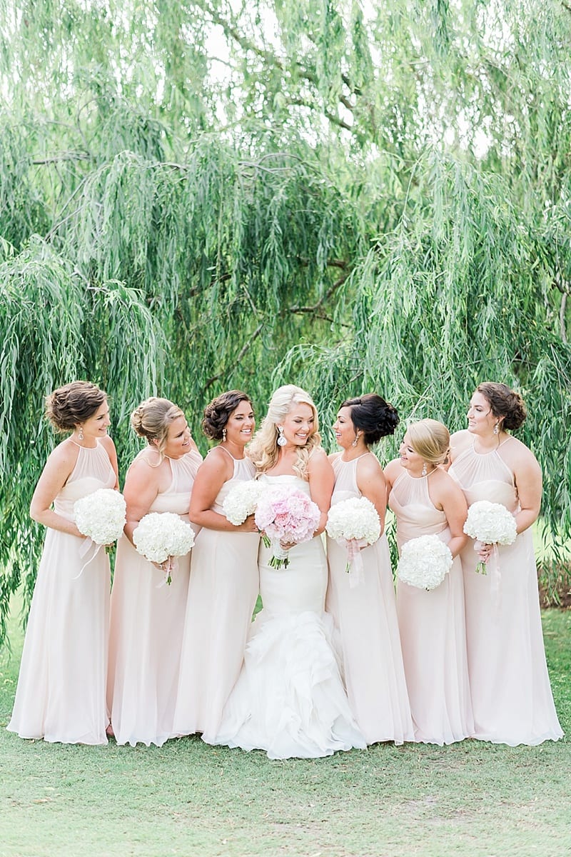 bridesmaids in blush under a willow tree photo