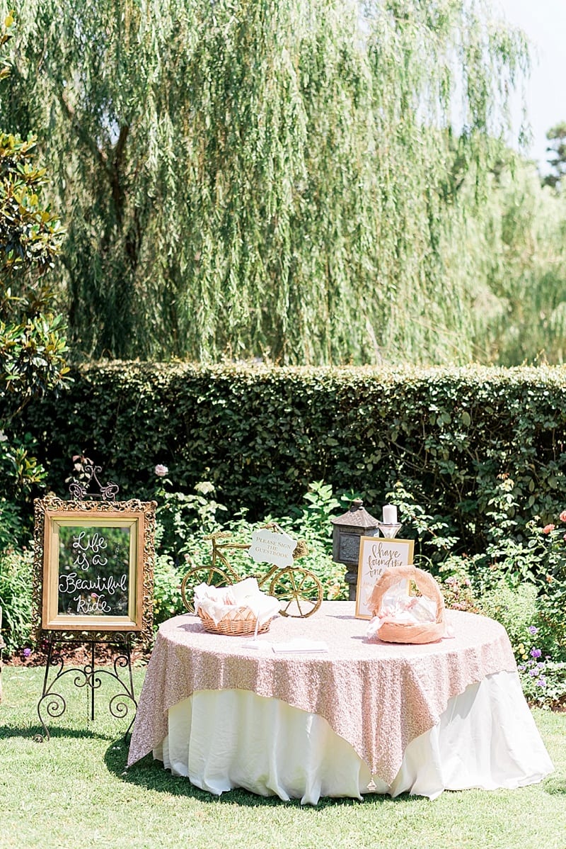 wedding welcome table and guestbook under a willow tree photo