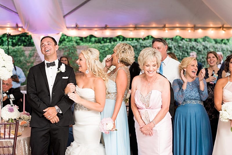 family laughing during wedding toast photo