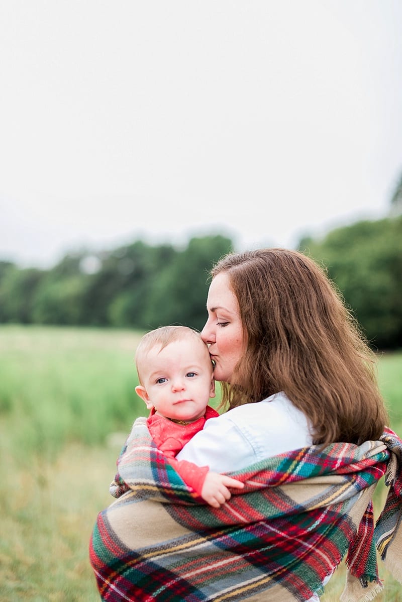 mom and baby wrapped in a plaid blanket photo