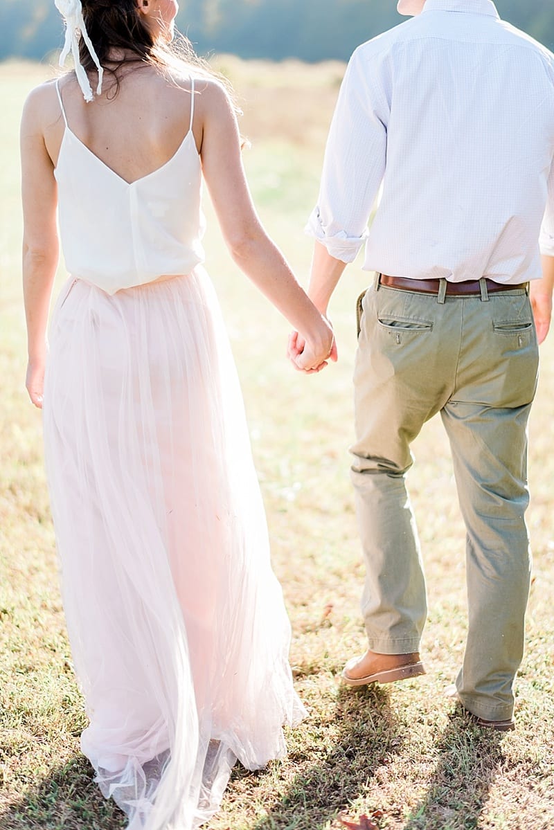 engagement couple holding hands and walking photo