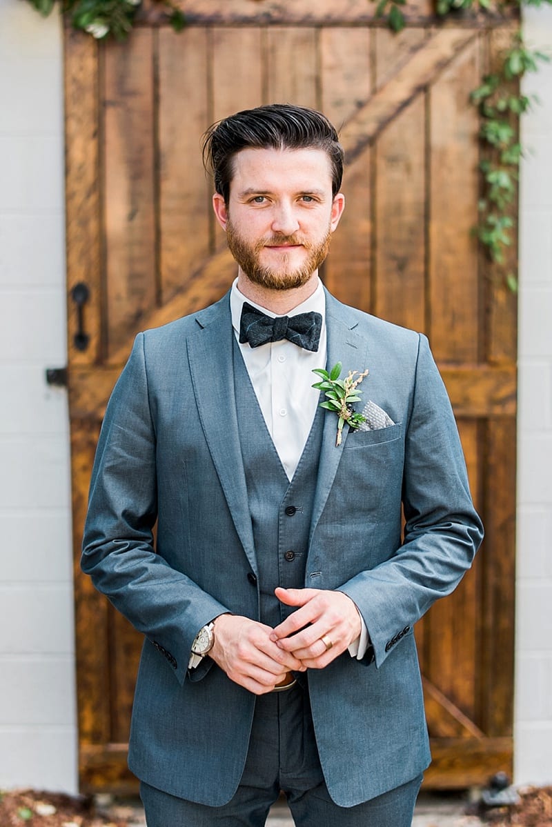 styled shoot groom with bowtie in gray suite photo