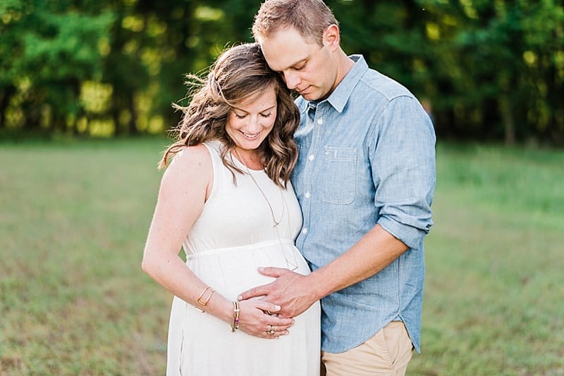 raleigh mother and father looking at pregnant belly photo