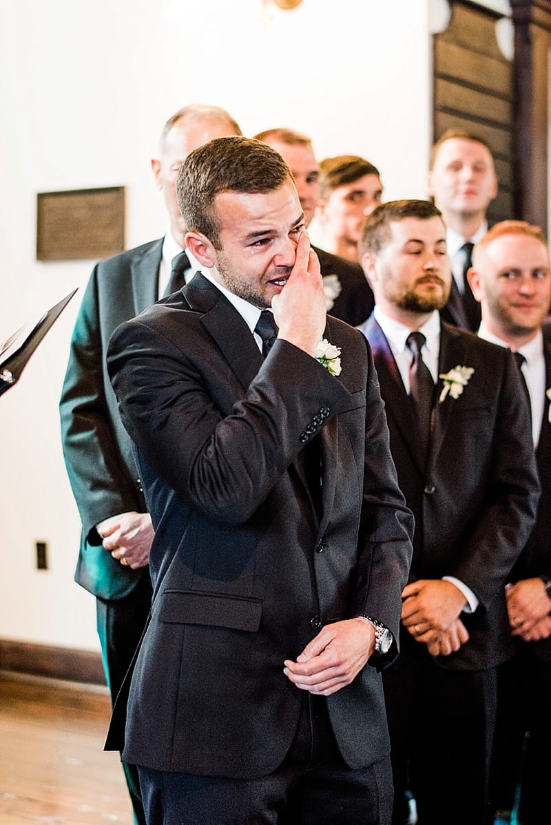 all saints chapel emotional groom watching bride come down the aisle photo