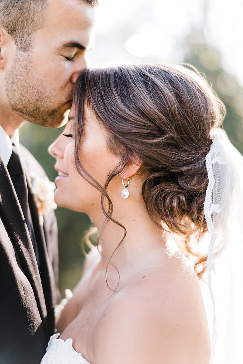 raleigh nc groom kissing bride on forehead photo