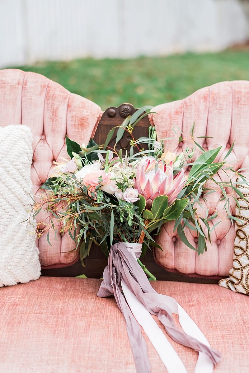 bowerbird flowers and apothecary bouquet on velvet couch photo