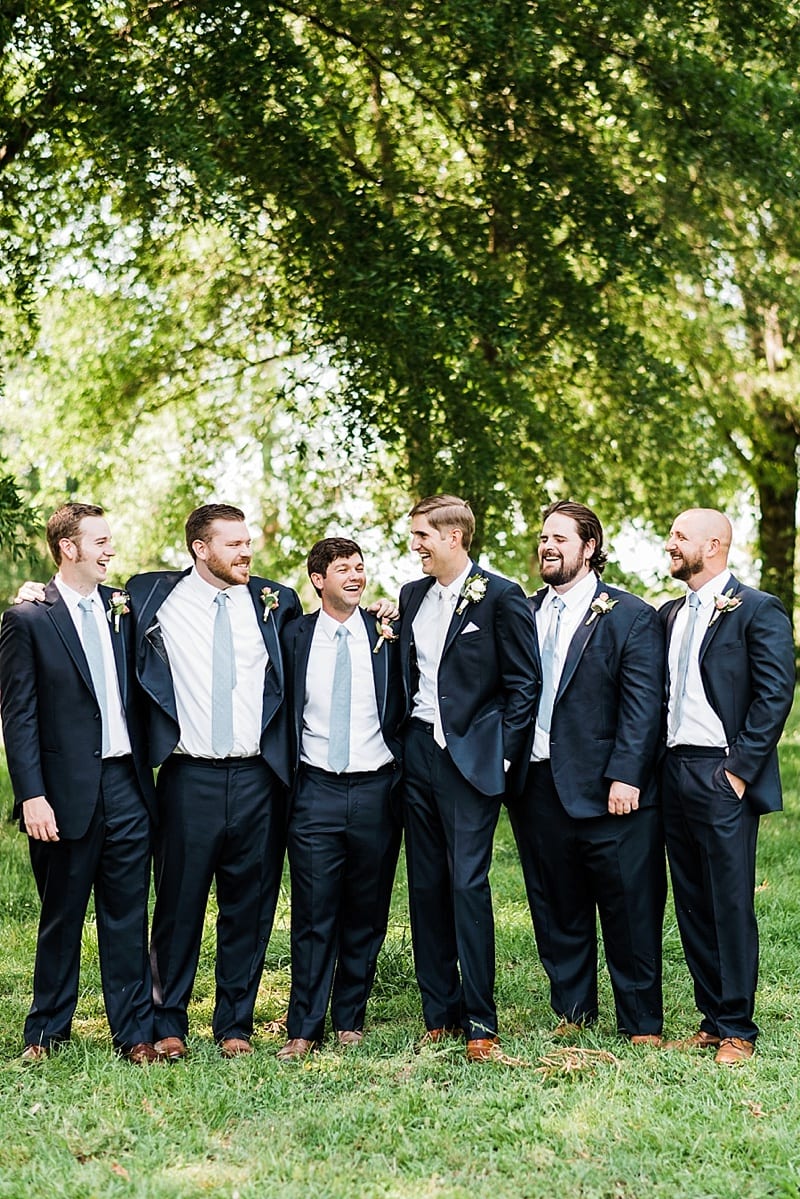 oaks at salem groom laughing with groomsmen photo