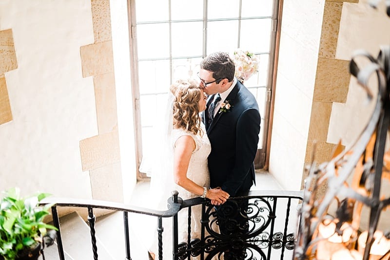 graylyn estate bride and groom kissing in stairwell photo