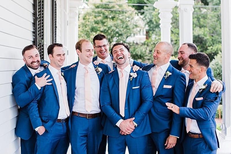 groom and groomsmen laughing photo