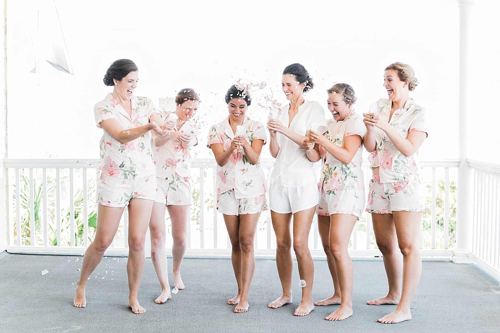 bridesmaids shooting confetti floral pajamas photo