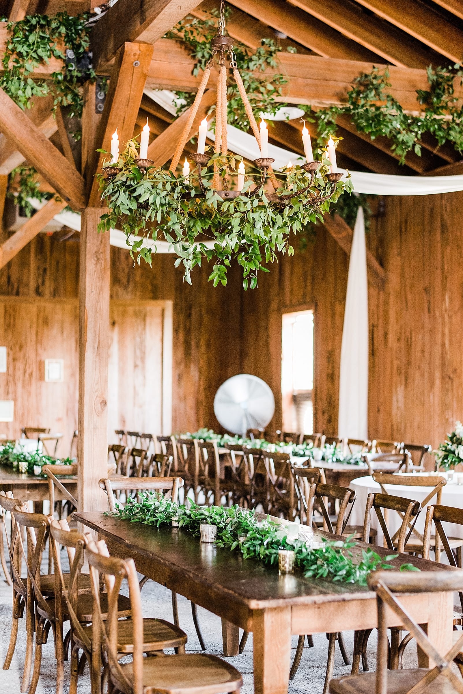 the cotton dock wedding reception boone hall plantation wooden chairs greenery chandelier photo