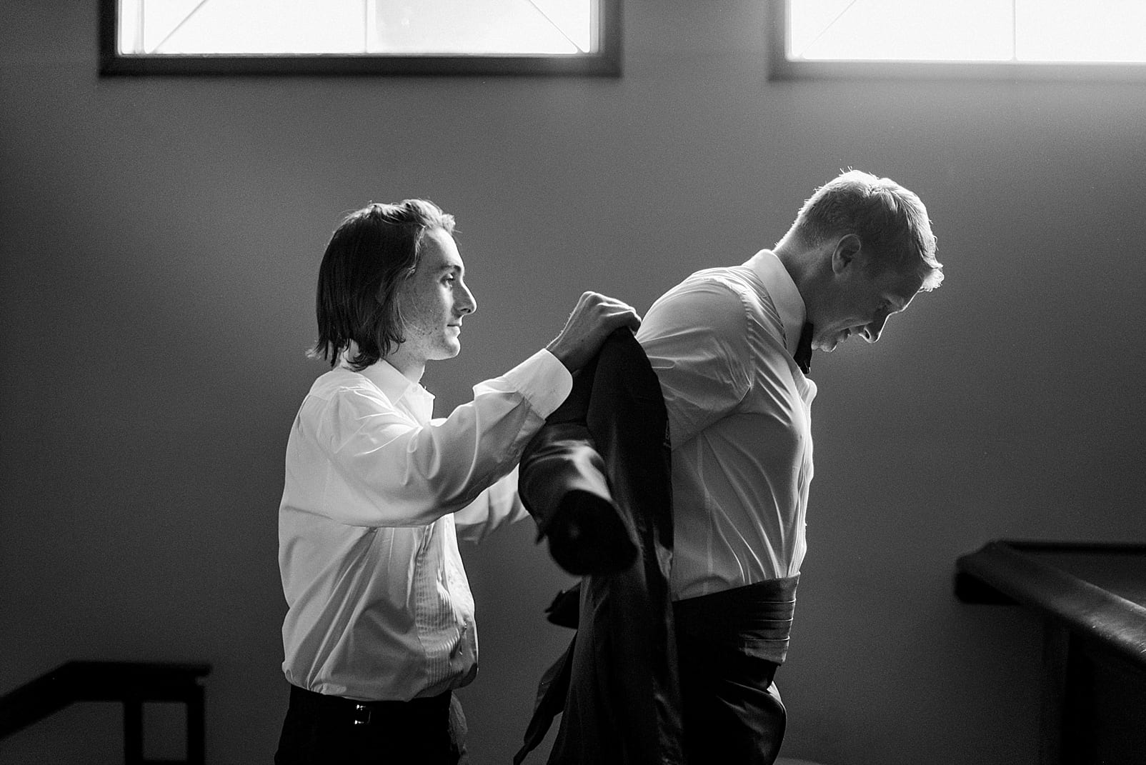 james river wedding photographer groom getting ready suit jacket photo