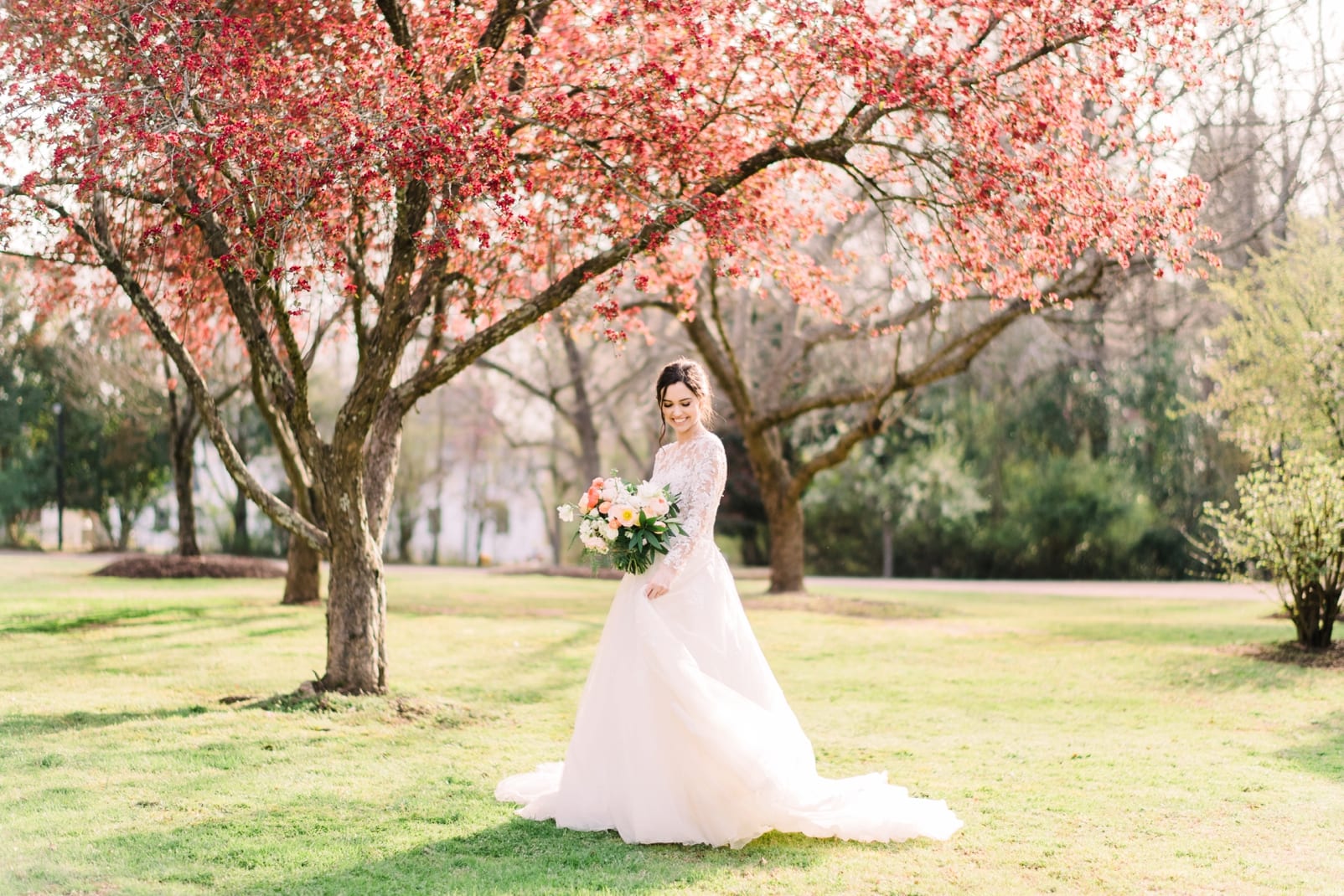 teighla norris hair and makeup on bride with tre bella wedding dress in sunlit field photo