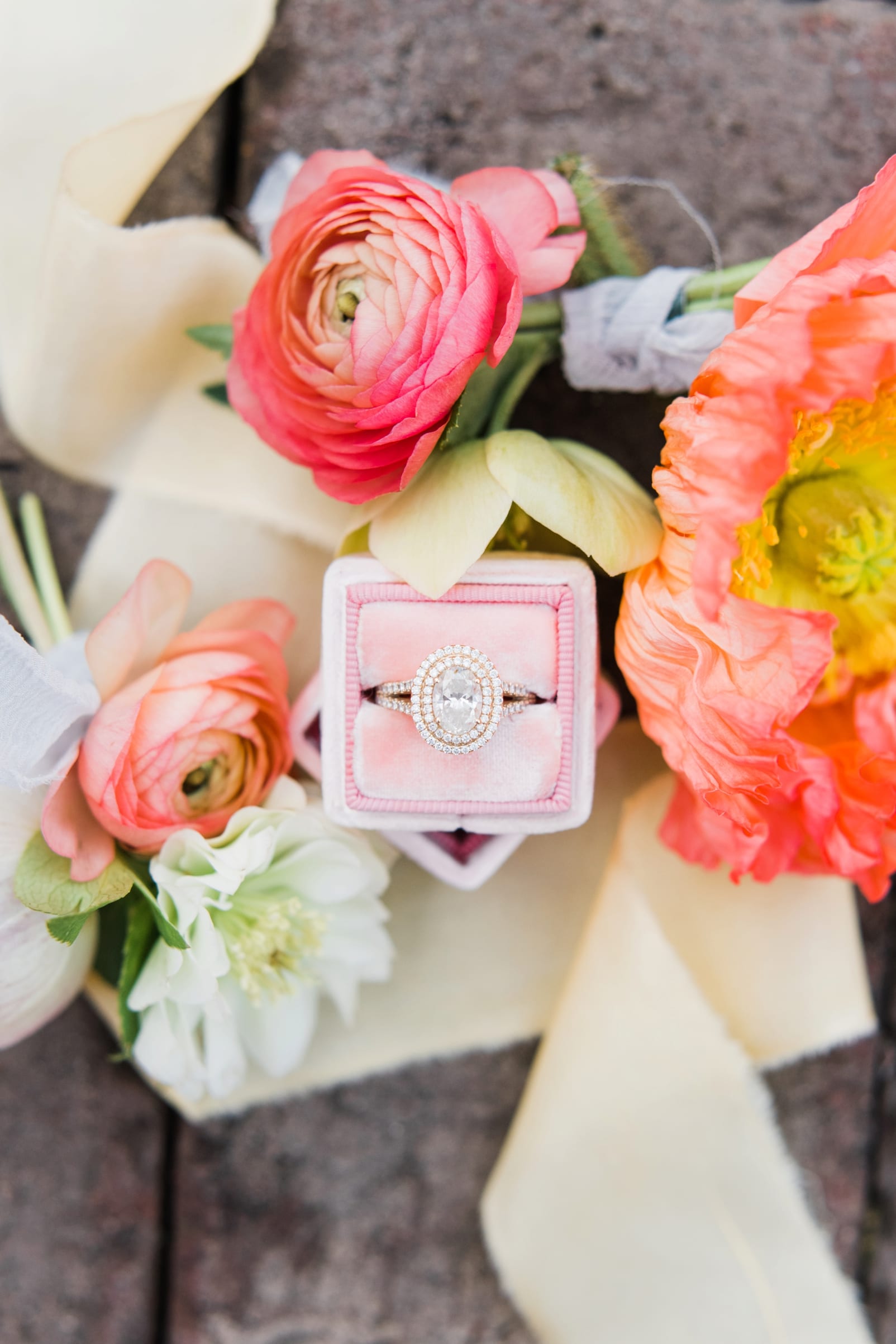 Kast events & company flat lay with florals and engagement ring photo