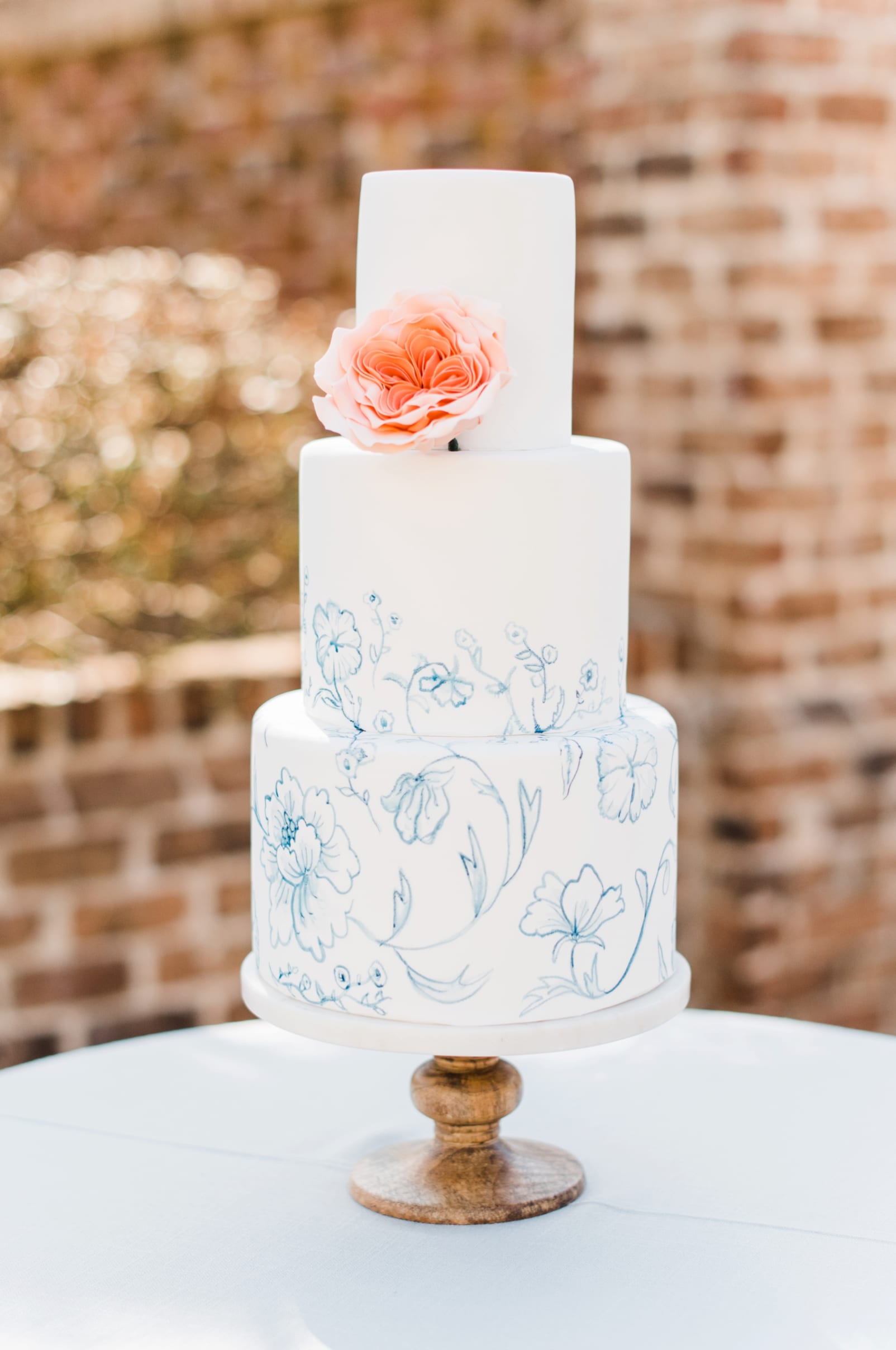 The cupcake shoppe 3 tiered wedding cake with light blue floral designs photo