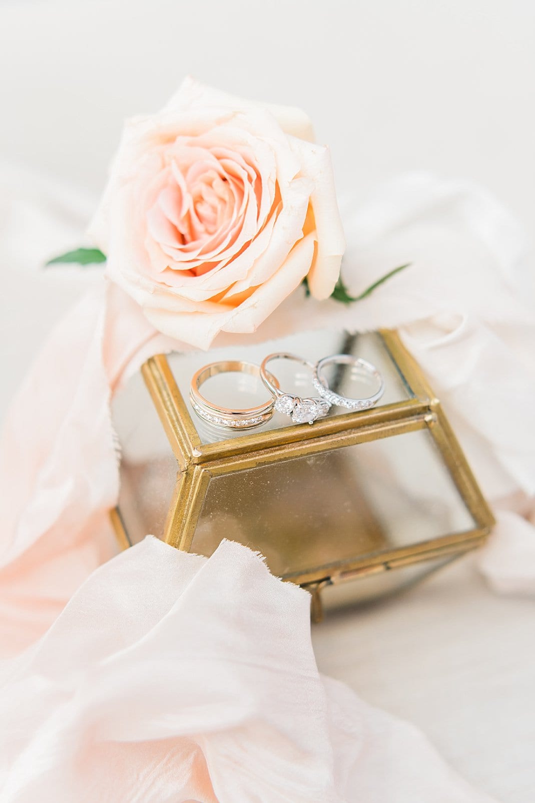 chapel hill, nc bride and groom rings on gold rimmed glass jewelry box photo