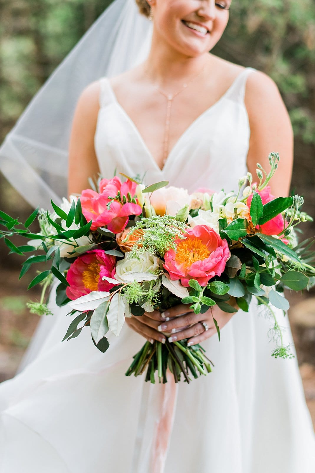 wild Flora Farm bridal bouquet with bright coral, peach flowers and greenery photo