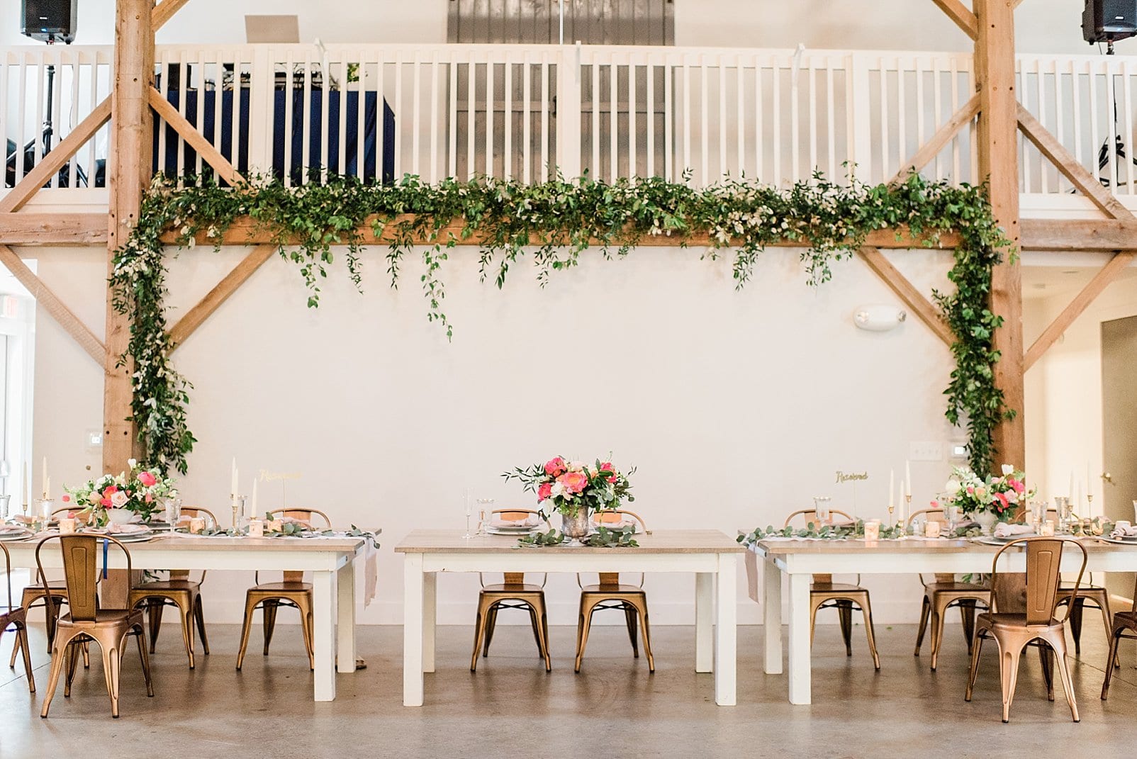 barn at chapel hill wedding reception head table with floral centerpiece and draped greenery photo