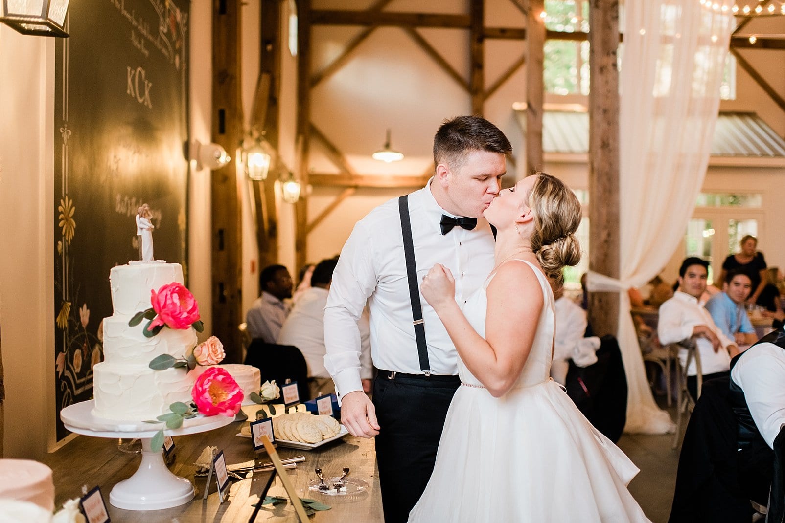 barn at chapel hill bride and groom kissing at wedding reception photo