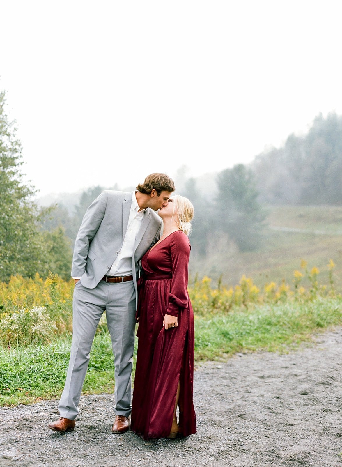 boone engagement session bride and groom kissing on gravel path photo