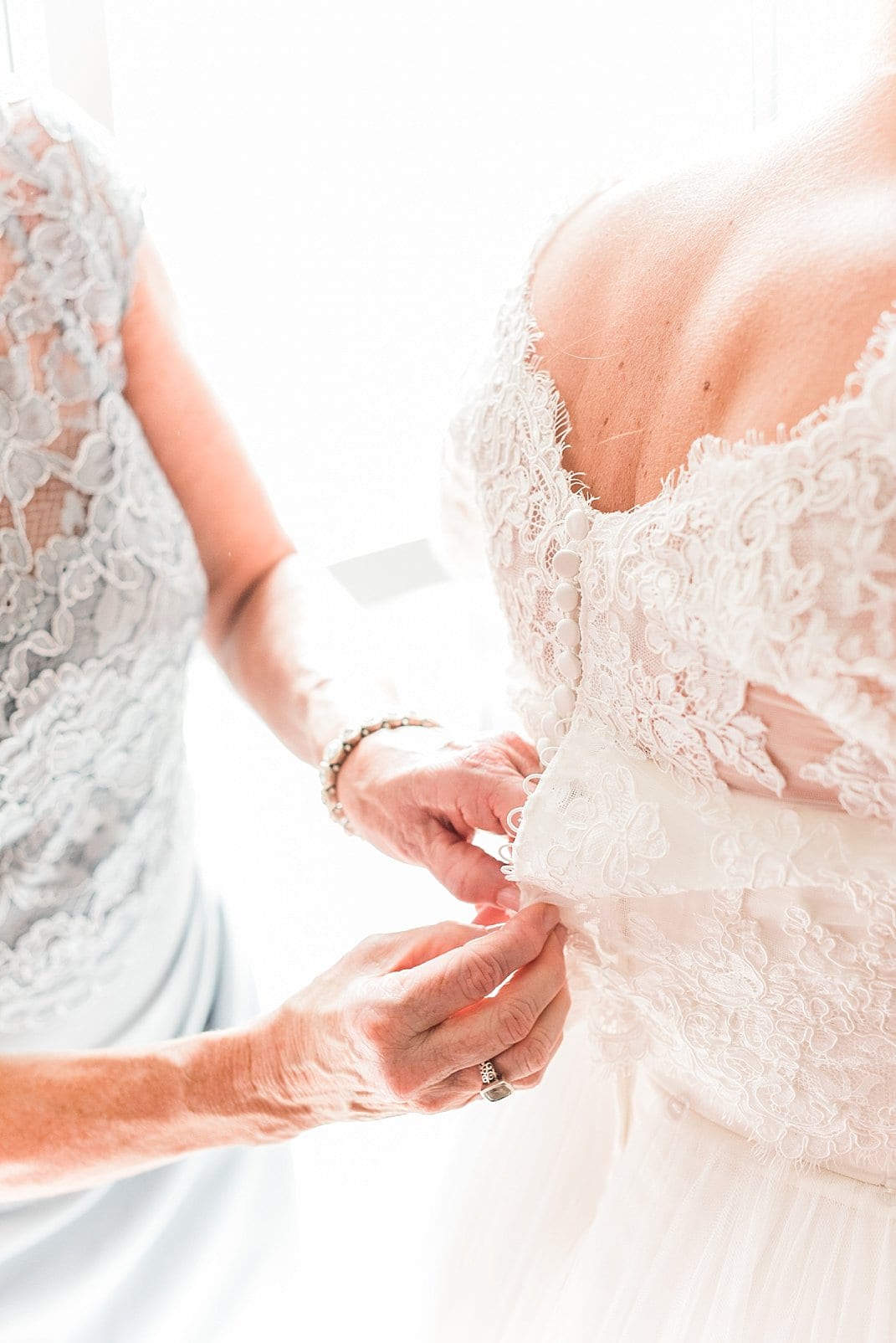 raleigh, nc mother of bride buttoning brides lace dress photo