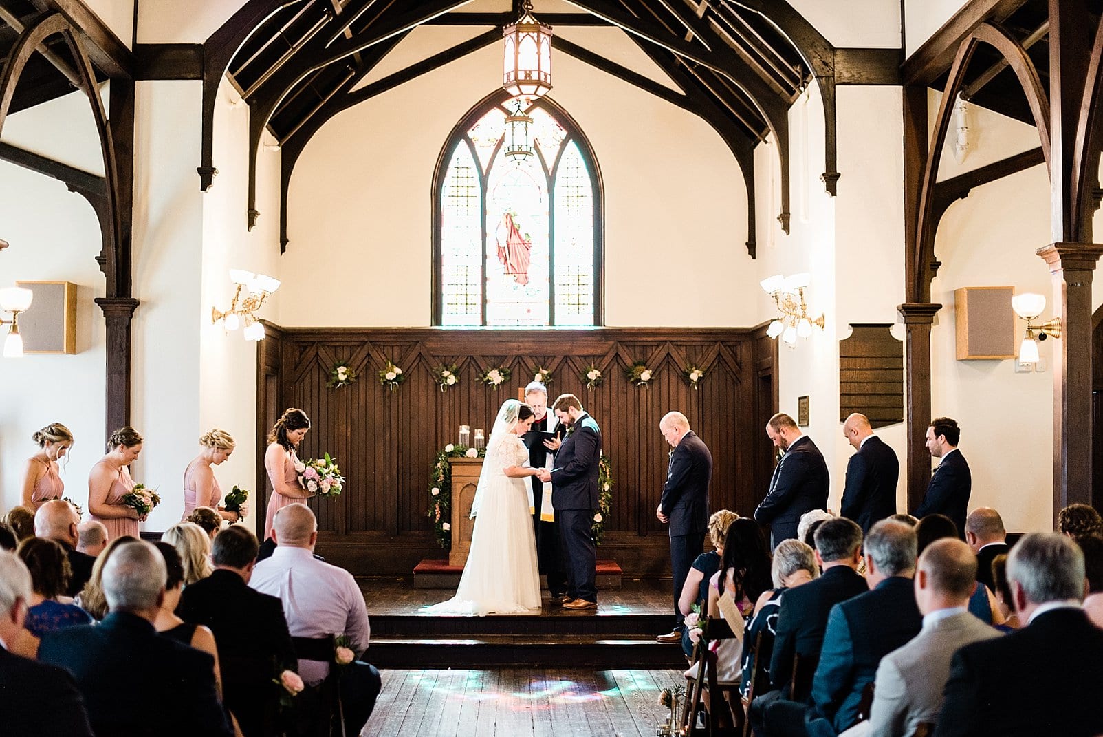 downtown raleigh wedding ceremony bride and groom exchanging rings photo