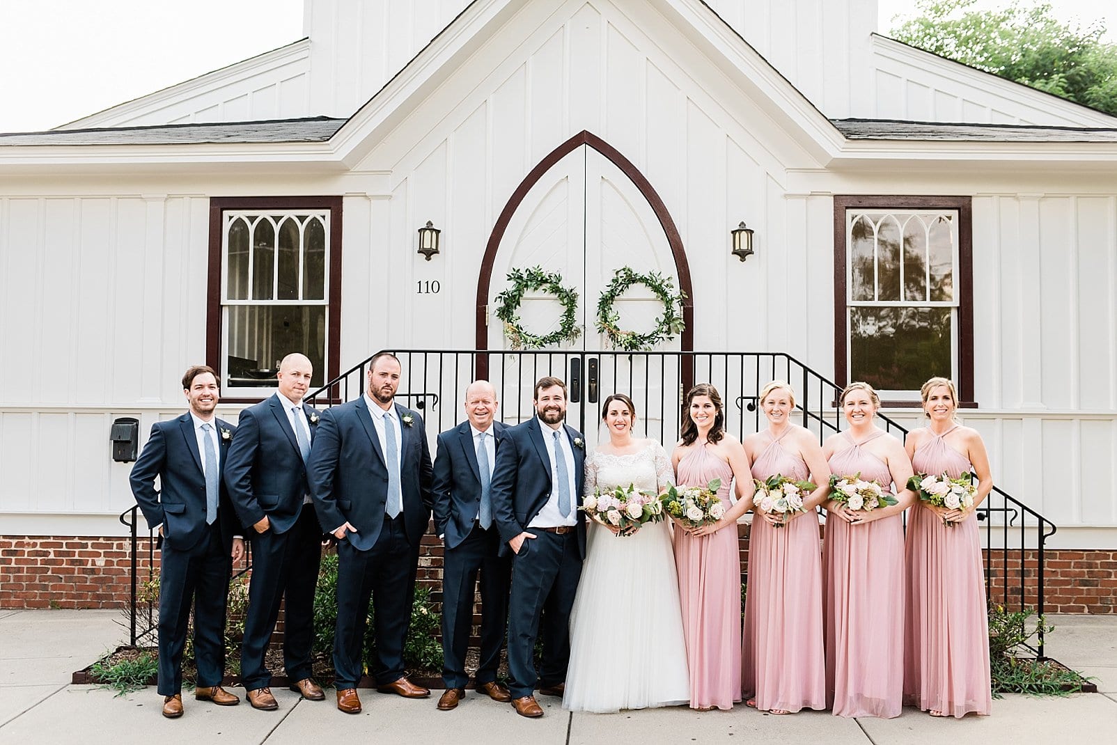 raleigh, nc bride and groom with bridal party in front of venue photo