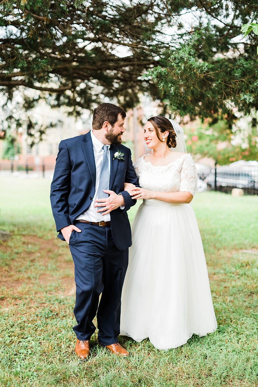 downtown raleigh wedding bride and groom walking under a tree photo