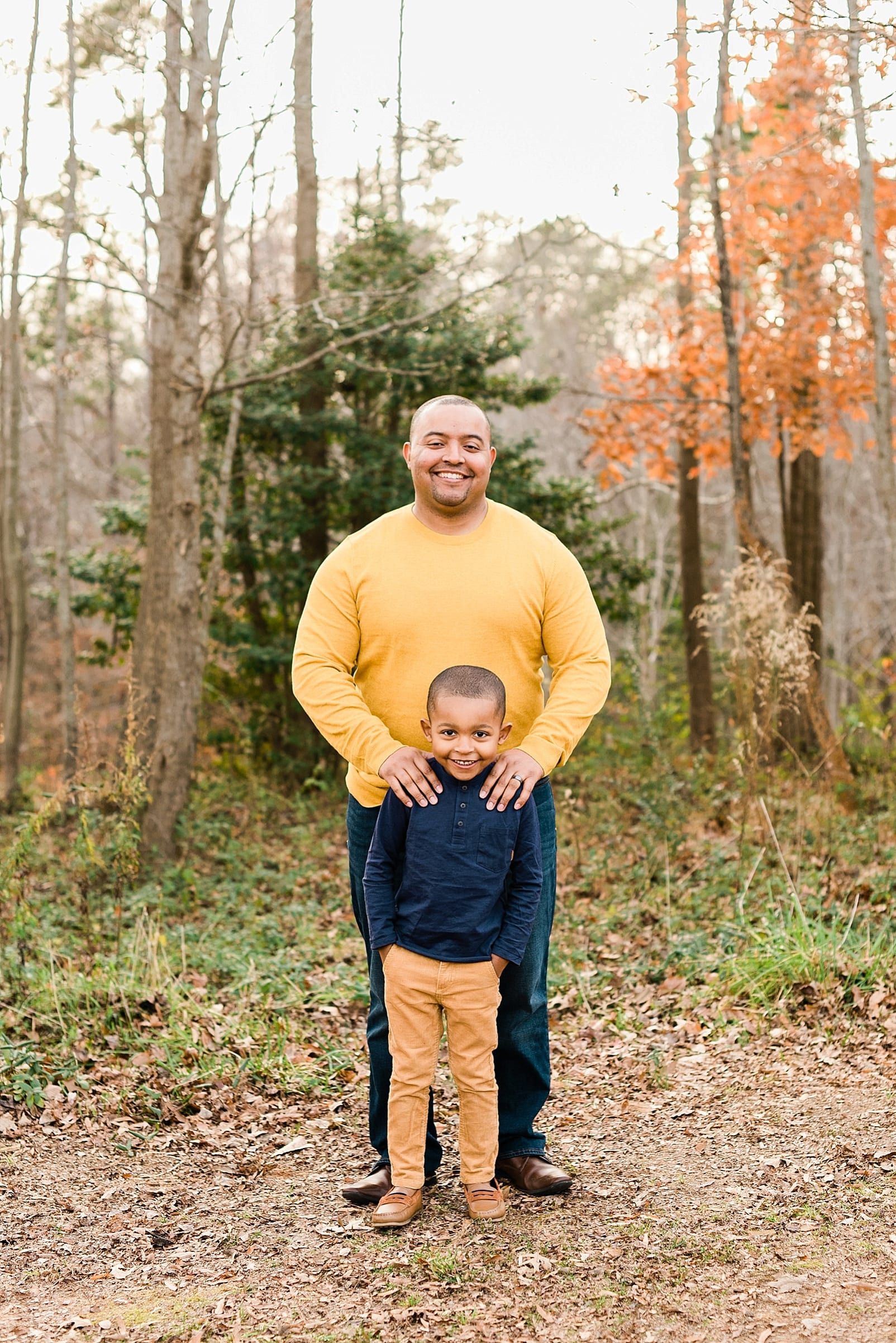 wake forest father standing with his hands on his son's shoulders photo
