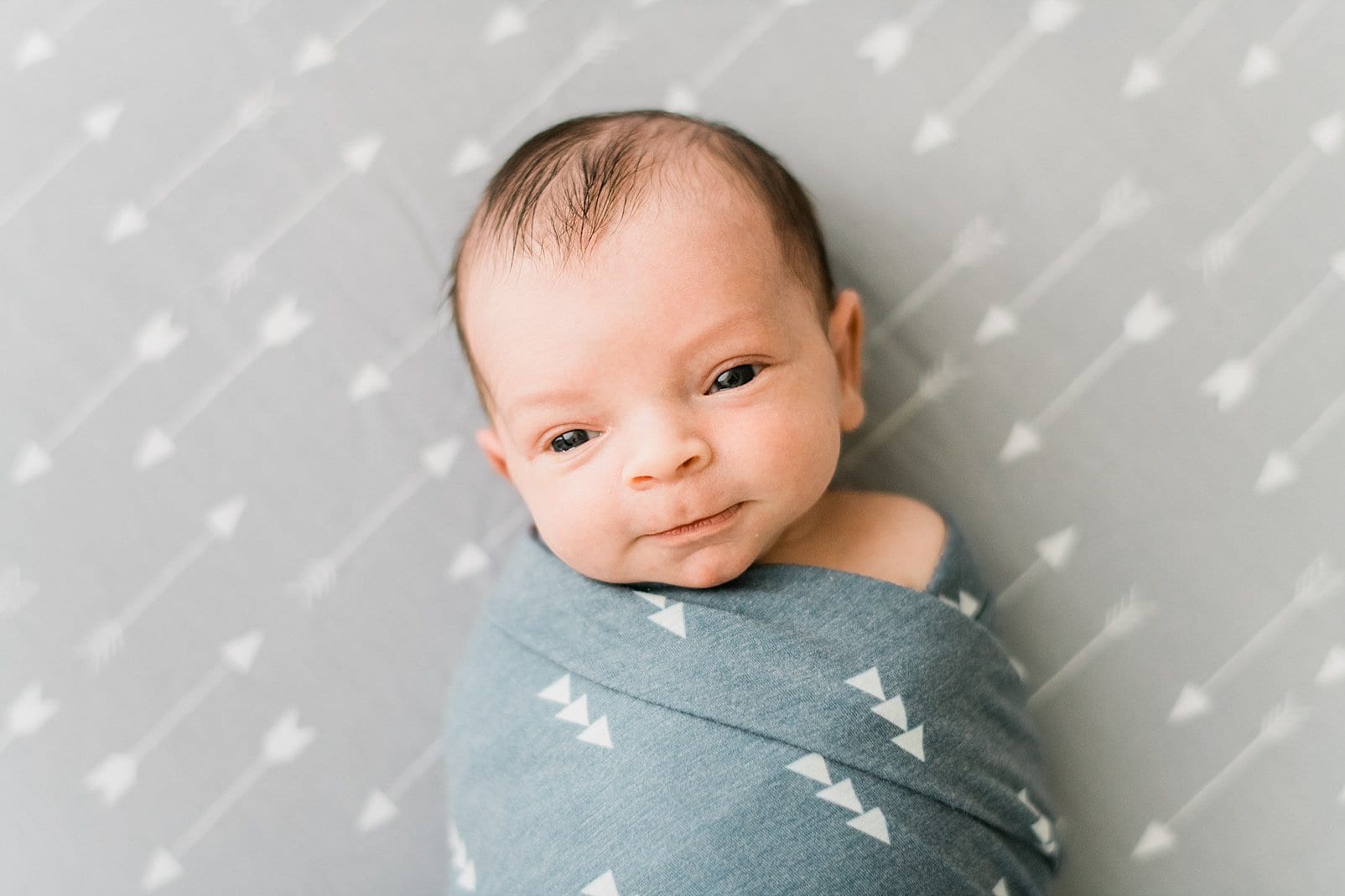 raleigh newborn portrait with arrow blanket photo