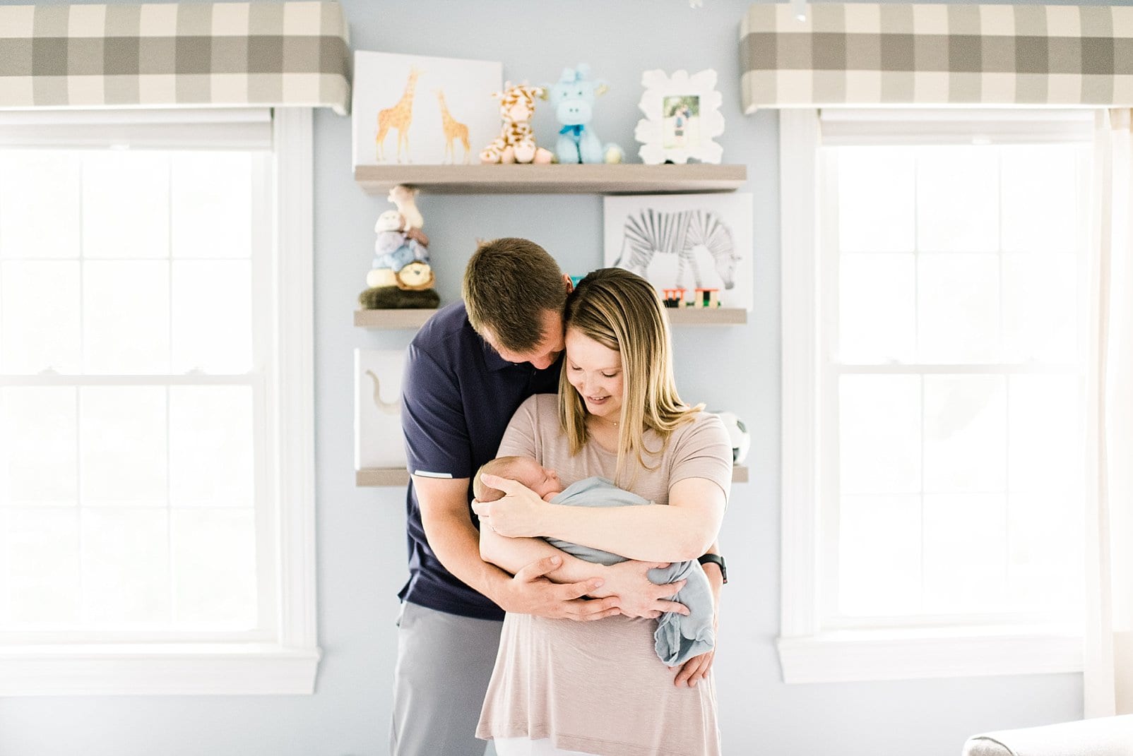 raleigh mother and father snuggled in front of bookshelf photo