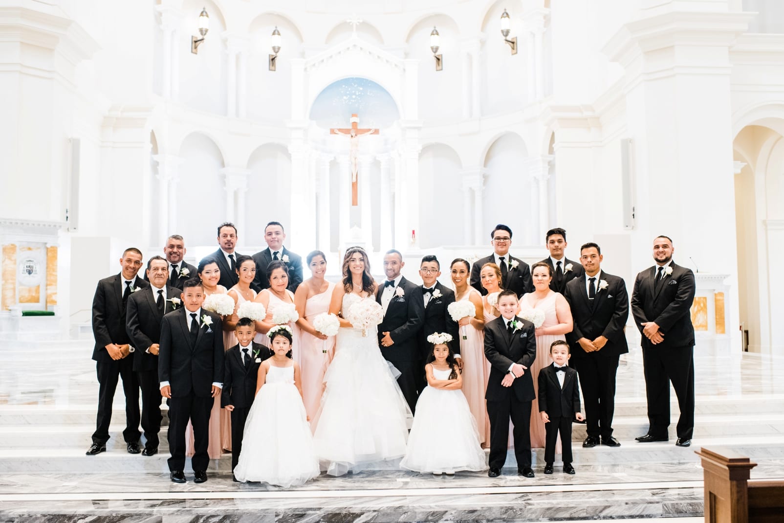 Raleigh, NC bride and groom with full wedding party in the Holy Name of Jesus Cathedral sanctuary photo