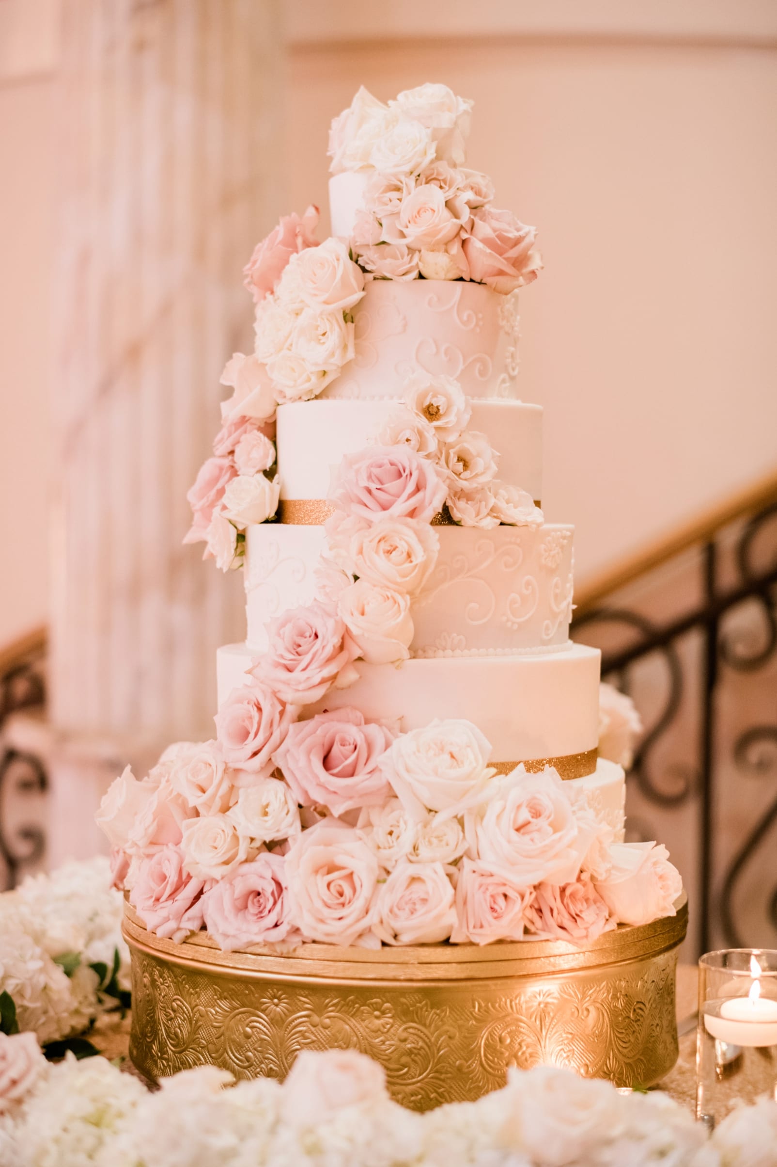 Cinda's Creative Cakes 6 tiered wedding cake with fresh white and link pink flowers cascading down the front photo