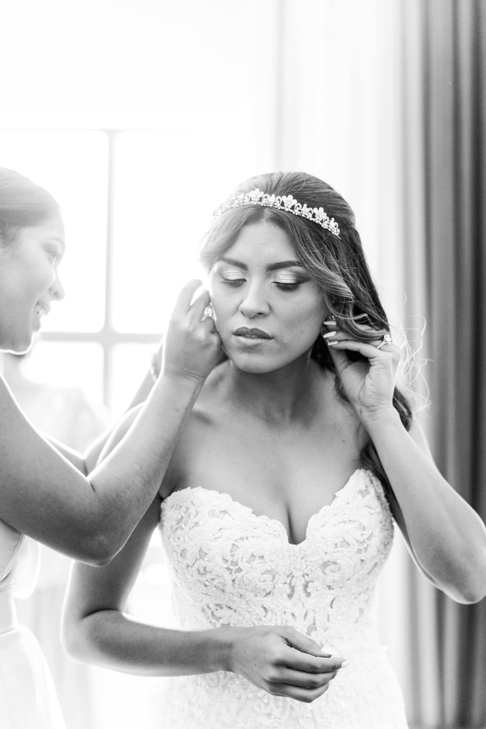 Raleigh, NC bride putting in her earrings photo in black and white photo