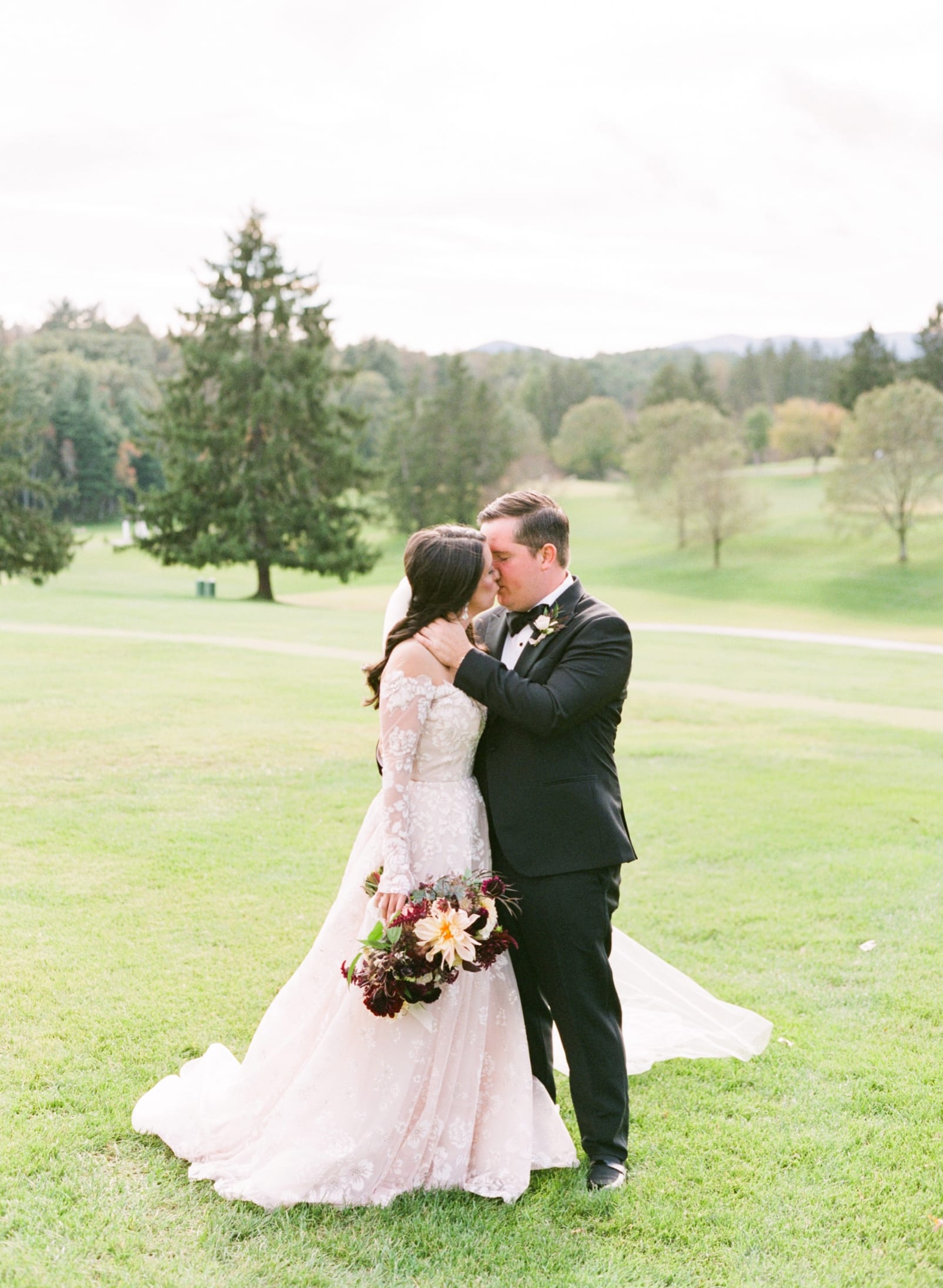 Biltmore Forest Country Club bride and groom kissing on the golf course photo