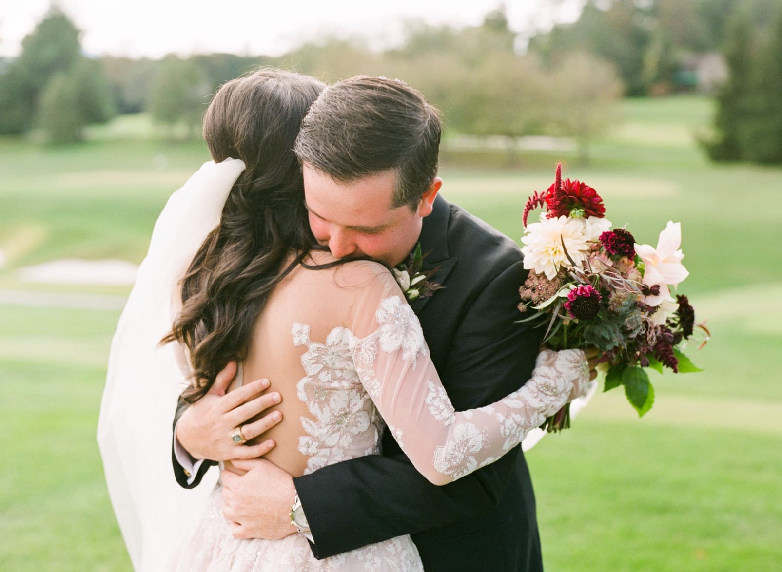 Biltmore Forest Country Club bride and groom embracing during first look photo