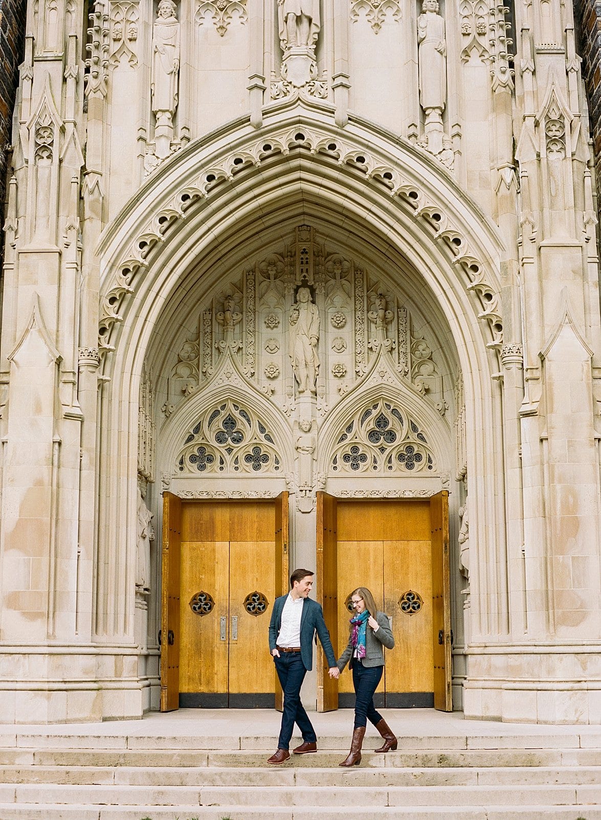 Duke chapel couple standing in front of the wooden doors photo